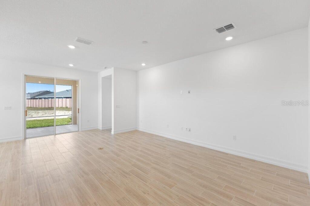 3320 Northwest 52nd Avenue Road Ocala, FL 34482 - Photo 8 of 25 a view of an empty room with wooden floor and a window