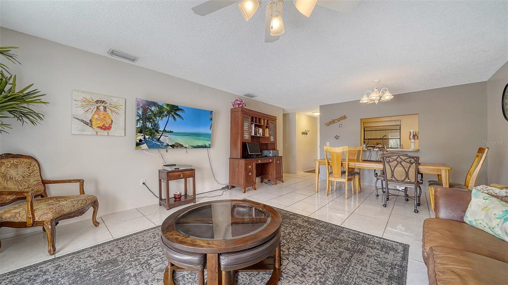 9034 Midnight Pass Road, Unit 6 Sarasota, FL 34242 - Photo 12 of 58 a living room with furniture and wooden floor