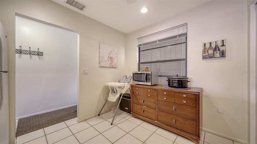 9034 Midnight Pass Road, Unit 6 Sarasota, FL 34242 - Photo 16 of 58 a room with cabinets and washer