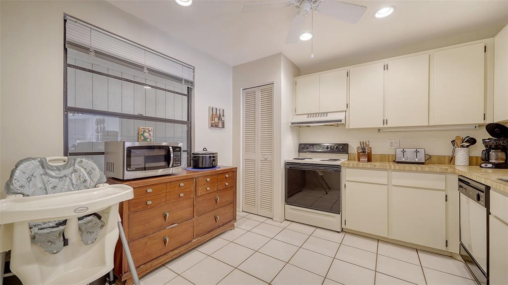 9034 Midnight Pass Road, Unit 6 Sarasota, FL 34242 - Photo 17 of 58 a kitchen with a sink cabinets and window