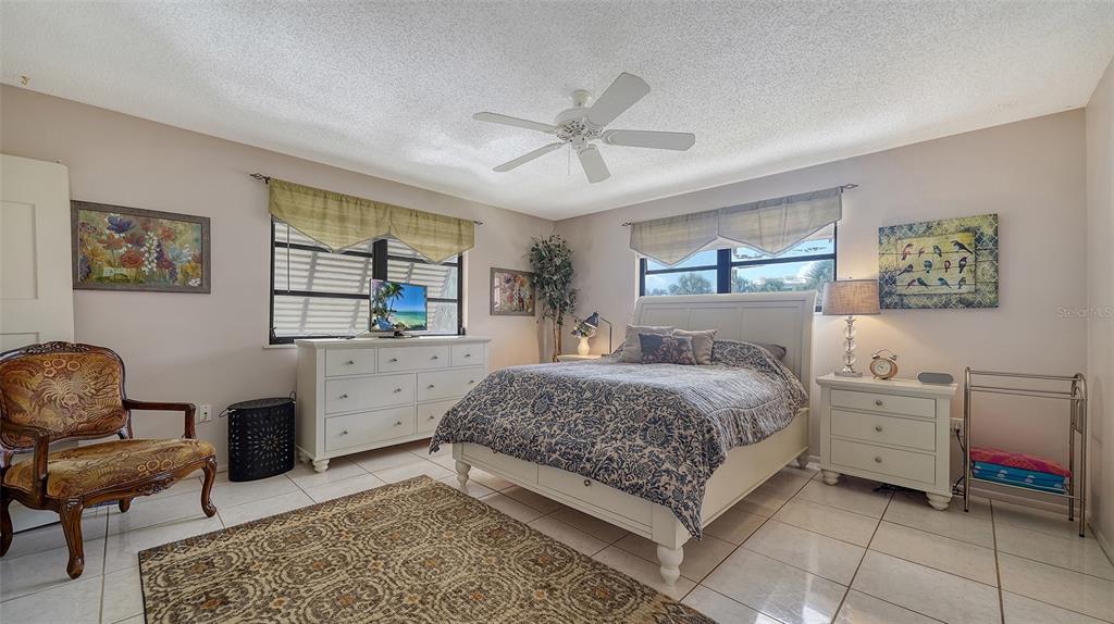 9034 Midnight Pass Road, Unit 6 Sarasota, FL 34242 - Photo 20 of 58 a bedroom with a bed and furniture