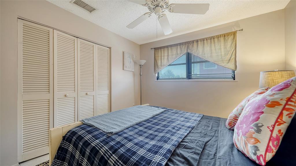 9034 Midnight Pass Road, Unit 6 Sarasota, FL 34242 - Photo 26 of 58 a bedroom with a bed and a window