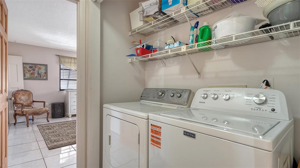 9034 Midnight Pass Road, Unit 6 Sarasota, FL 34242 - Photo 28 of 58 a utility room with dryer and washer