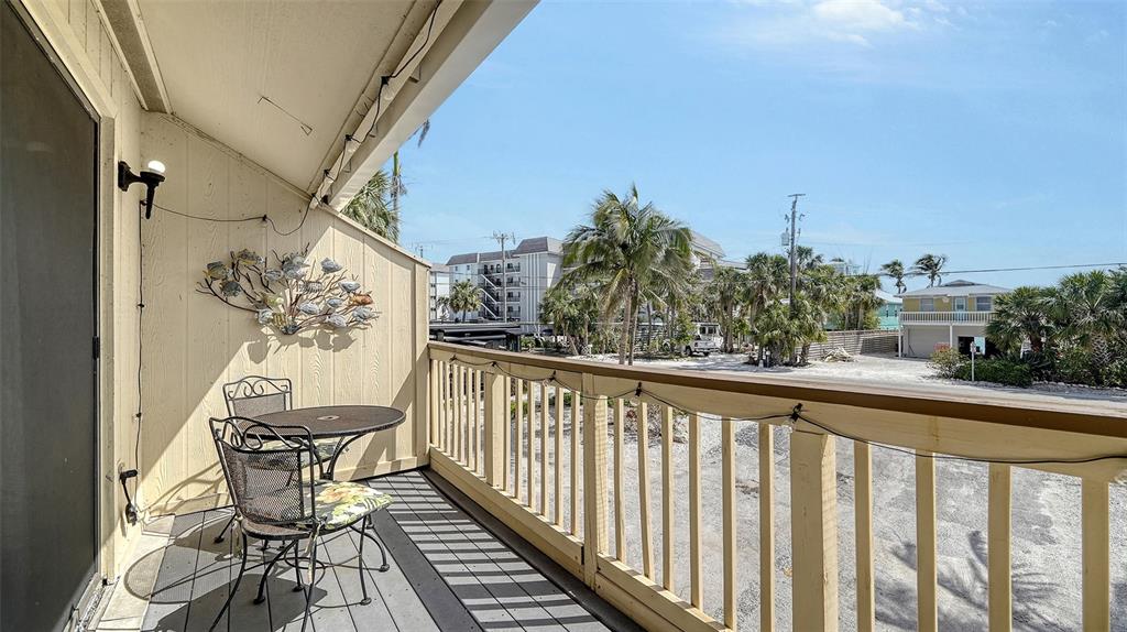 9034 Midnight Pass Road, Unit 6 Sarasota, FL 34242 - Photo 30 of 58 a view of a balcony with furniture