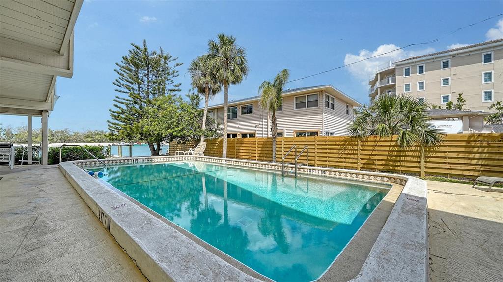 9034 Midnight Pass Road, Unit 6 Sarasota, FL 34242 - Photo 32 of 58 a view of swimming pool with a patio