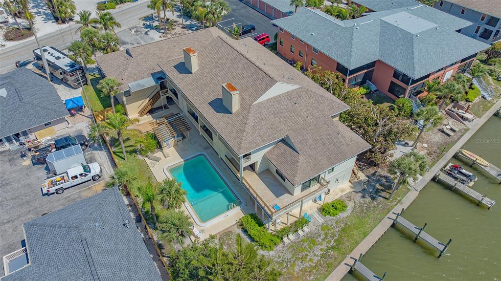 9034 Midnight Pass Road, Unit 6 Sarasota, FL 34242 - Photo 33 of 58 an aerial view of a house with a yard and potted plants