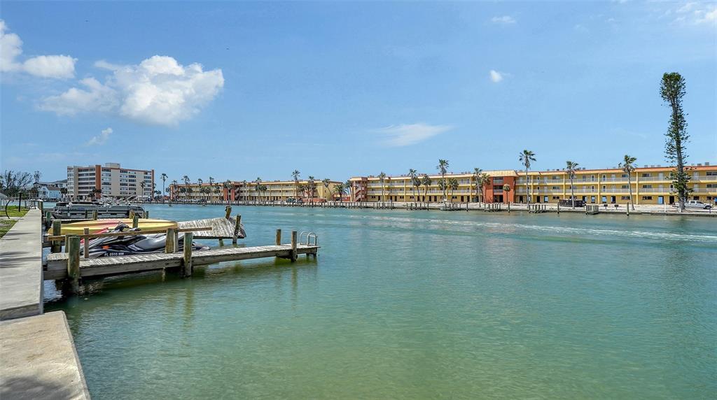 9034 Midnight Pass Road, Unit 6 Sarasota, FL 34242 - Photo 34 of 58 a view of a lake with boats and trees in the background
