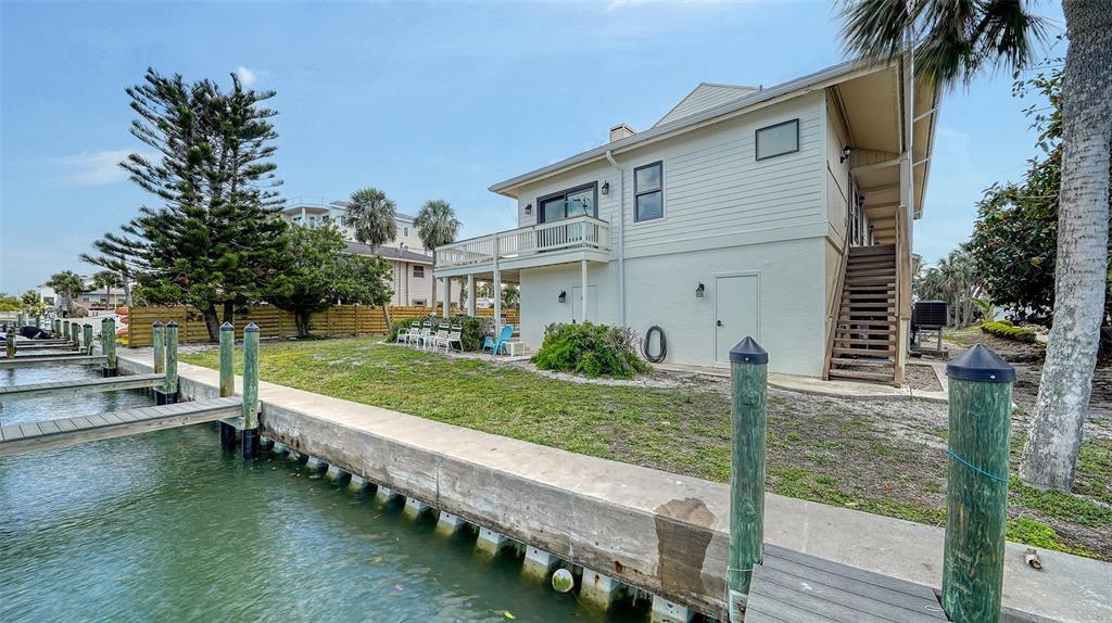 9034 Midnight Pass Road, Unit 6 Sarasota, FL 34242 - Photo 38 of 58 a view of a house with backyard and sitting area
