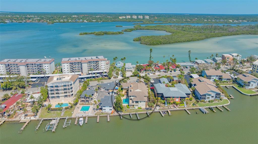 9034 Midnight Pass Road, Unit 6 Sarasota, FL 34242 - Photo 5 of 58 a view of a lake with a table and chairs