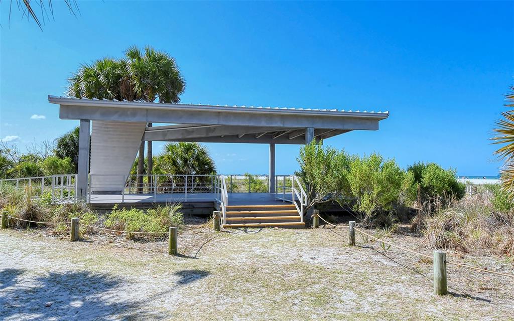 9034 Midnight Pass Road, Unit 6 Sarasota, FL 34242 - Photo 58 of 58 a backyard of a house with potted plants and large tree