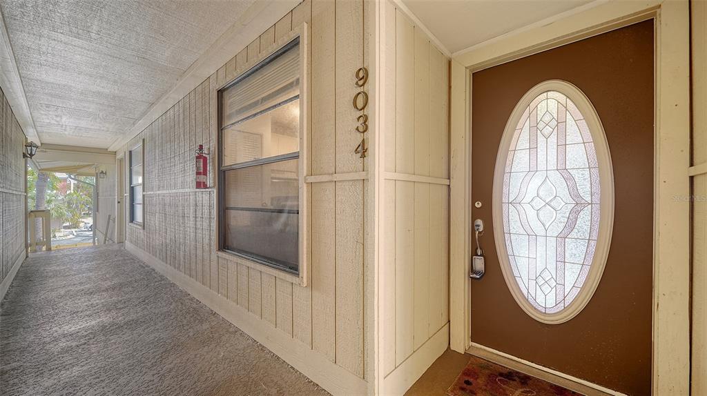 9034 Midnight Pass Road, Unit 6 Sarasota, FL 34242 - Photo 10 of 58 a view of a livingroom with wooden floor and a large window