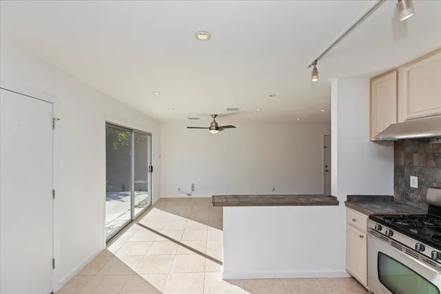 a view of kitchen with cabinets and stove