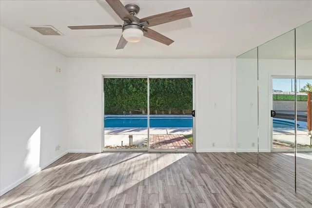 a view of a livingroom with a ceiling fan and window