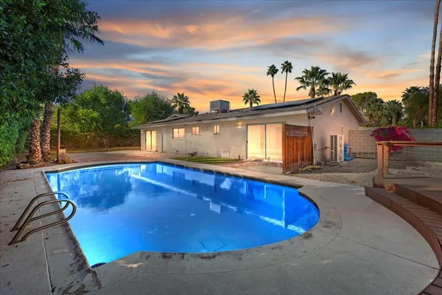 a view of a house with swimming pool and a porch