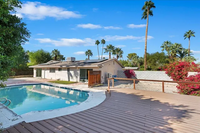 a view of a house with swimming pool and sitting area