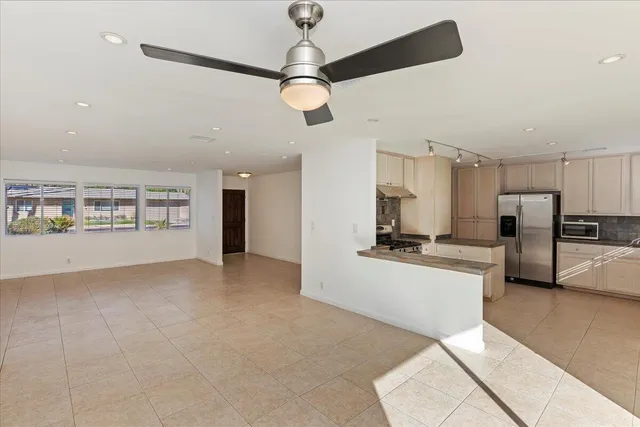 a view of a kitchen with a sink and refrigerator
