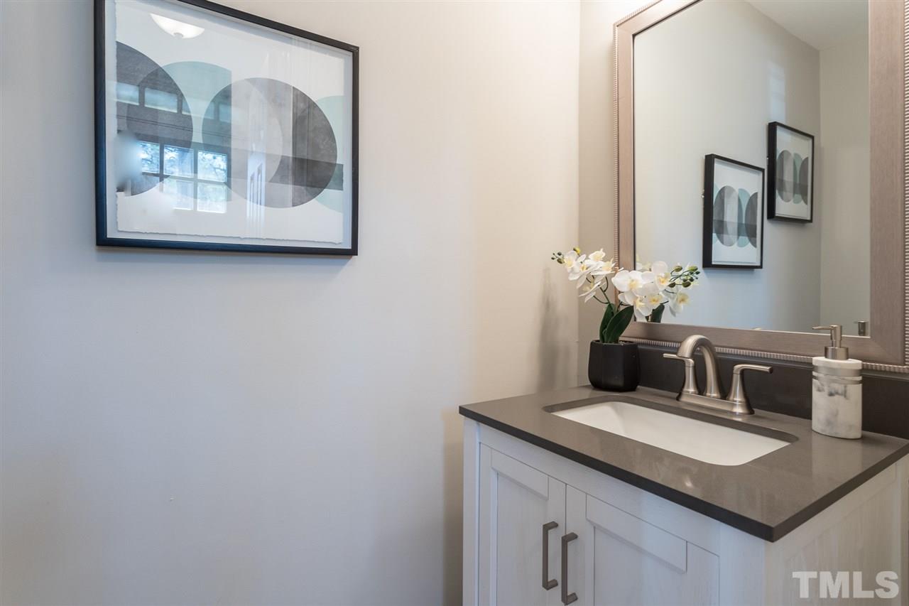 3117 East Folkestone Place Raleigh, NC 27604 - Photo 22 of 24 a bathroom with a granite countertop sink and a mirror
