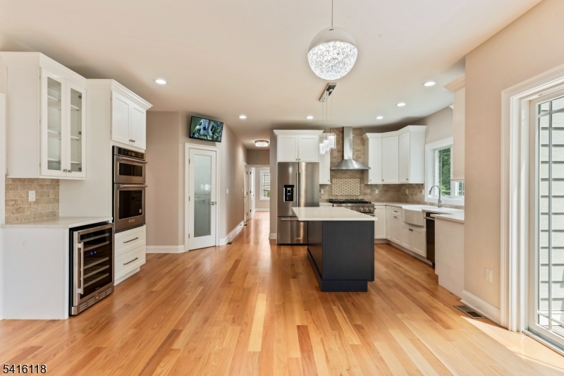 118 Cambridge Road Westfield, NJ 07090 - Photo 11 of 50 a large kitchen with a center island wooden floor stainless steel appliances and cabinets