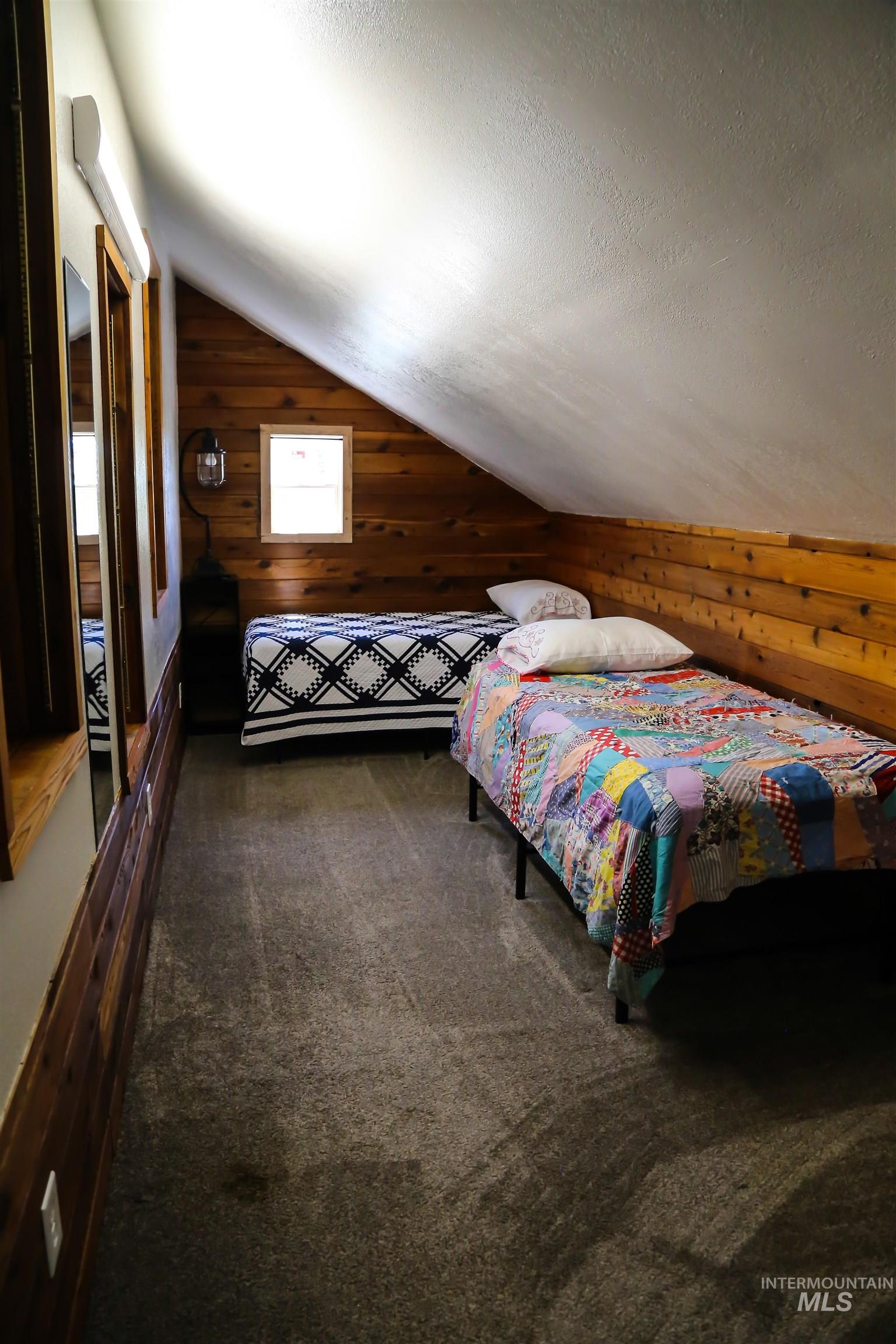 2060 Missman Road Council, ID 83612 - Photo 19 of 50 Bedroom featuring wooden walls and dark carpet