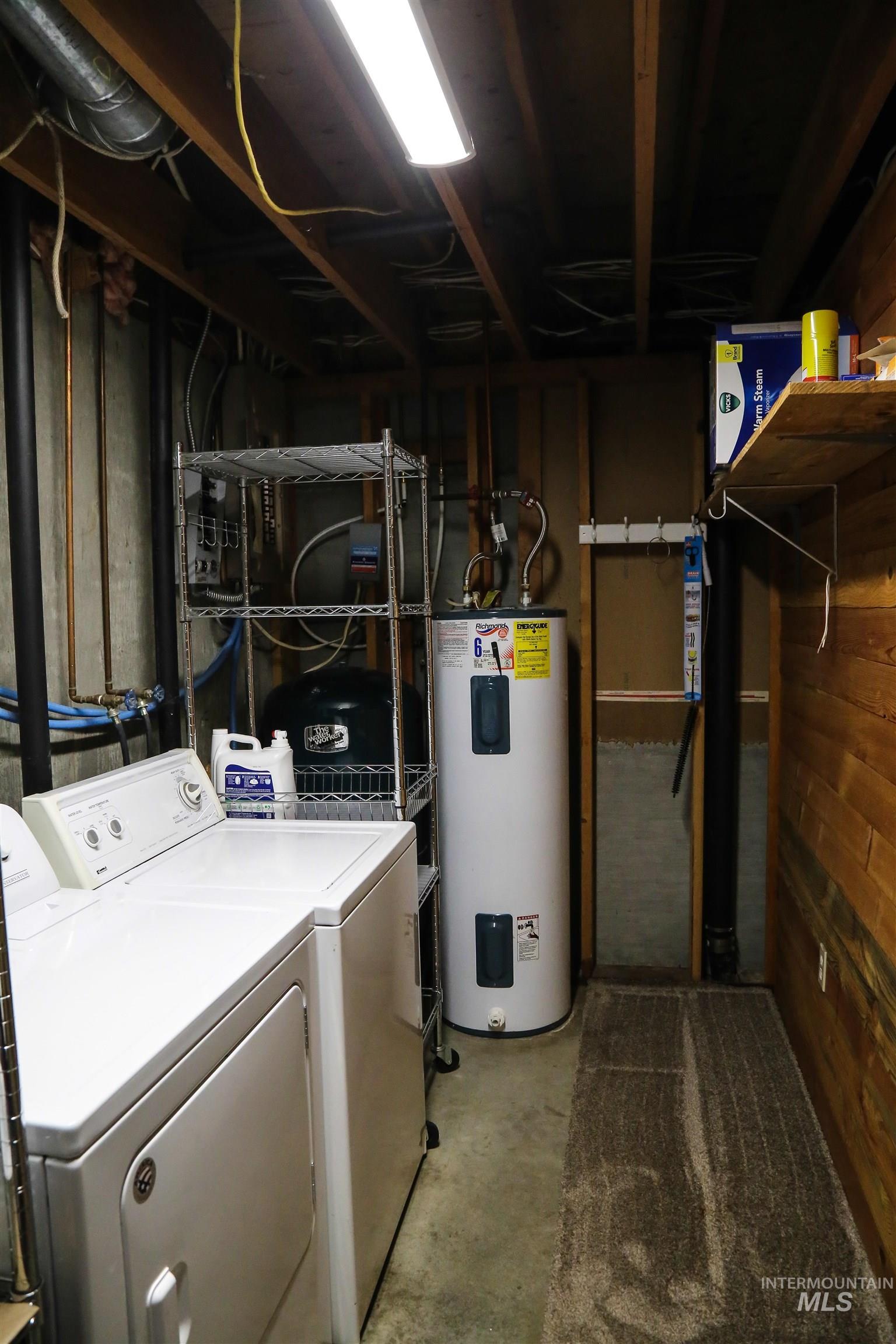2060 Missman Road Council, ID 83612 - Photo 28 of 50 Laundry area featuring unfinished concrete flooring, water heater, and independent washer and dryer