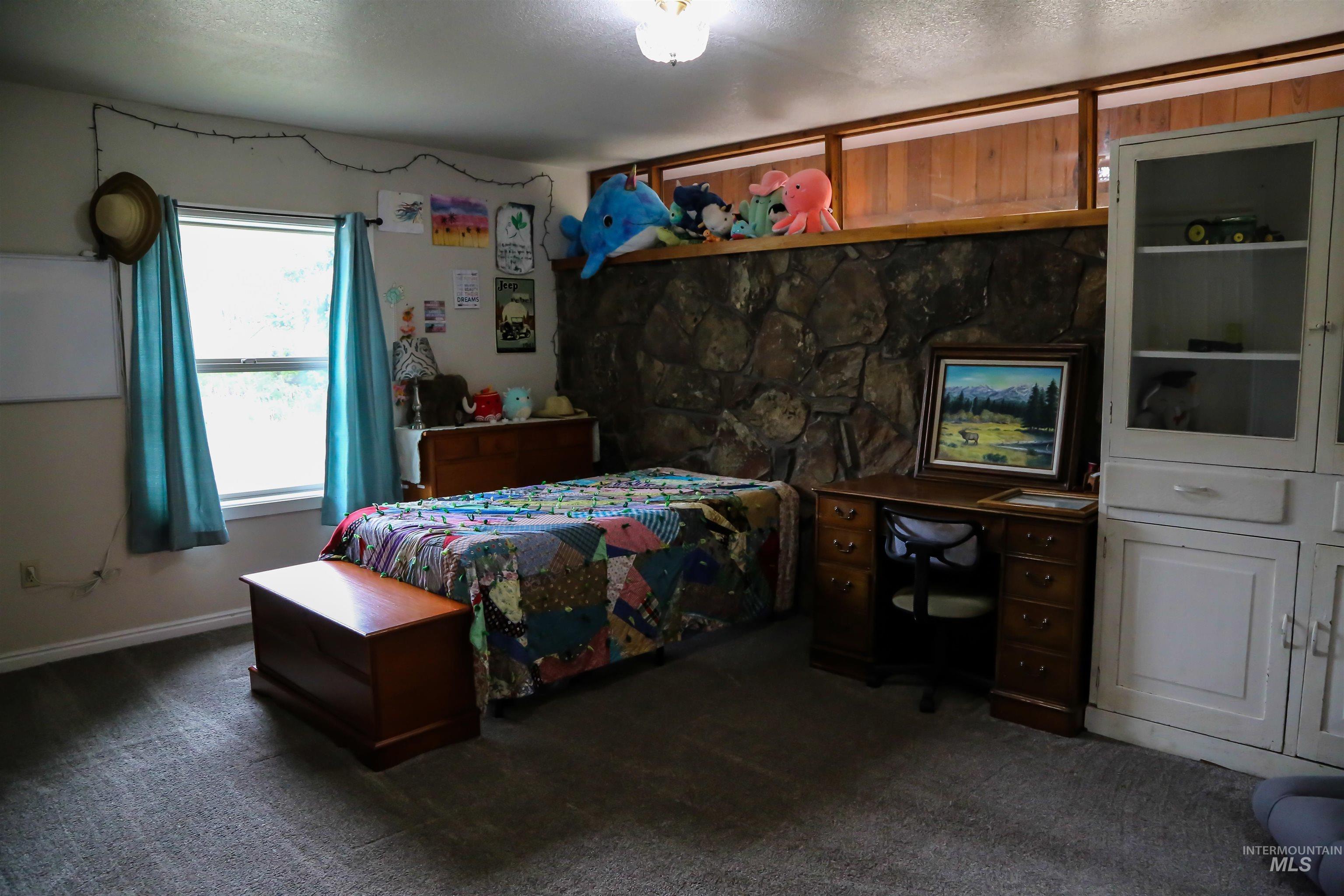 2060 Missman Road Council, ID 83612 - Photo 29 of 50 Bedroom featuring dark colored carpet, a desk, and a textured ceiling