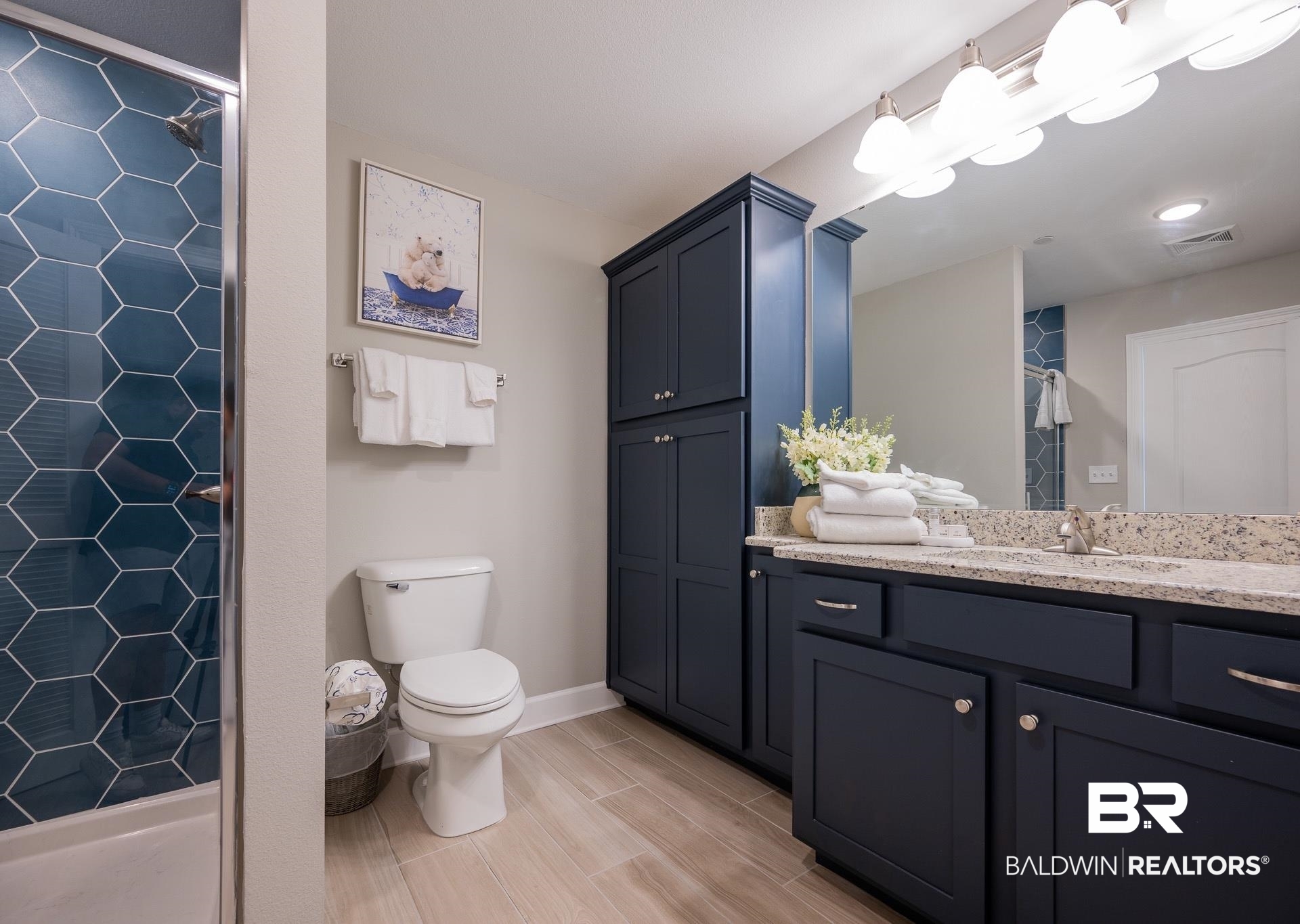 23008 Perdido Beach Boulevard, Unit 506 Orange Beach, AL 36561 - Photo 11 of 48 Full bath featuring visible vents, vanity, toilet, baseboards, and tiled shower