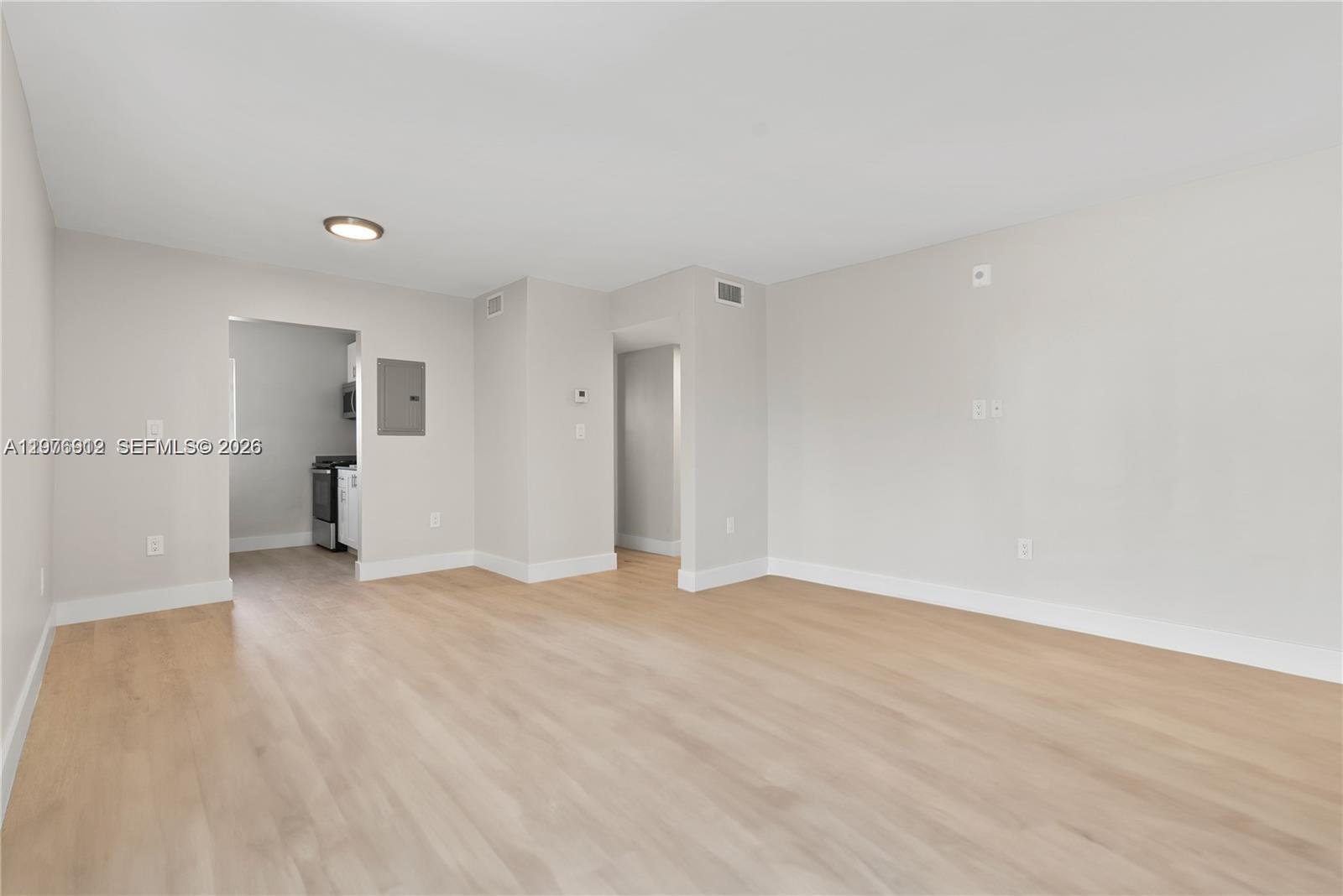 1101 Northeast 80th Street, Unit 201 Miami, FL 33138 - Photo 5 of 17 a view of empty room with wooden floor