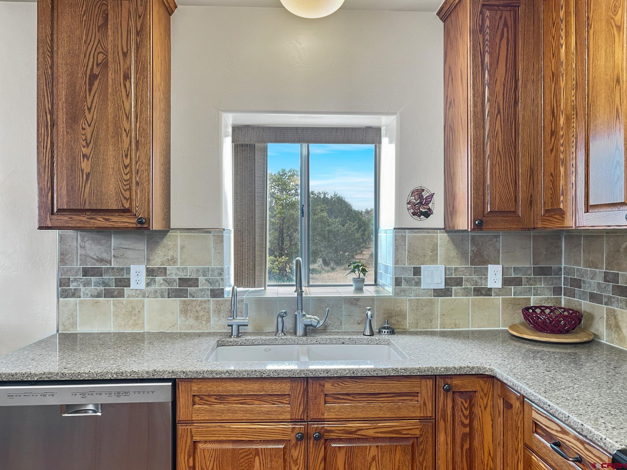 2984 Black Canyon Road Crawford, CO 81415 - Photo 12 of 35 a kitchen with stainless steel appliances granite countertop a sink a stove and a granite counter tops with wooden floors