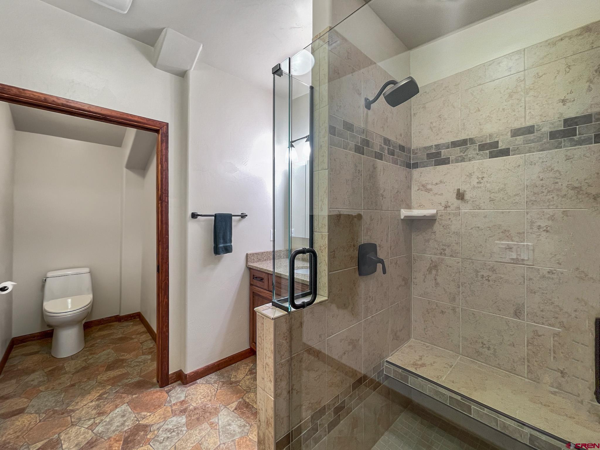 2984 Black Canyon Road Crawford, CO 81415 - Photo 17 of 35 a bathroom with a granite countertop shower mirror and toilet