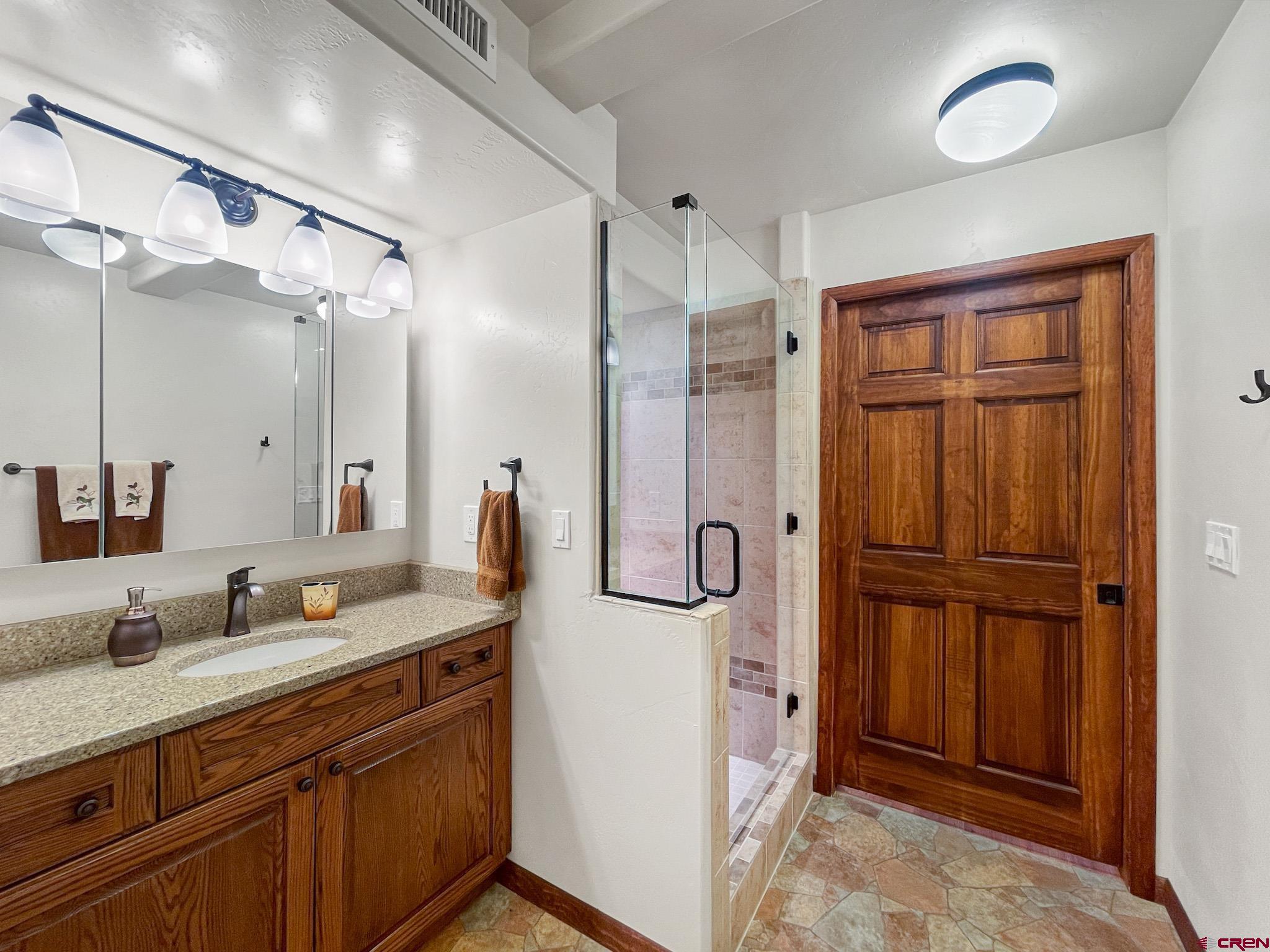 2984 Black Canyon Road Crawford, CO 81415 - Photo 24 of 35 a spacious bathroom with a granite countertop sink mirror and double