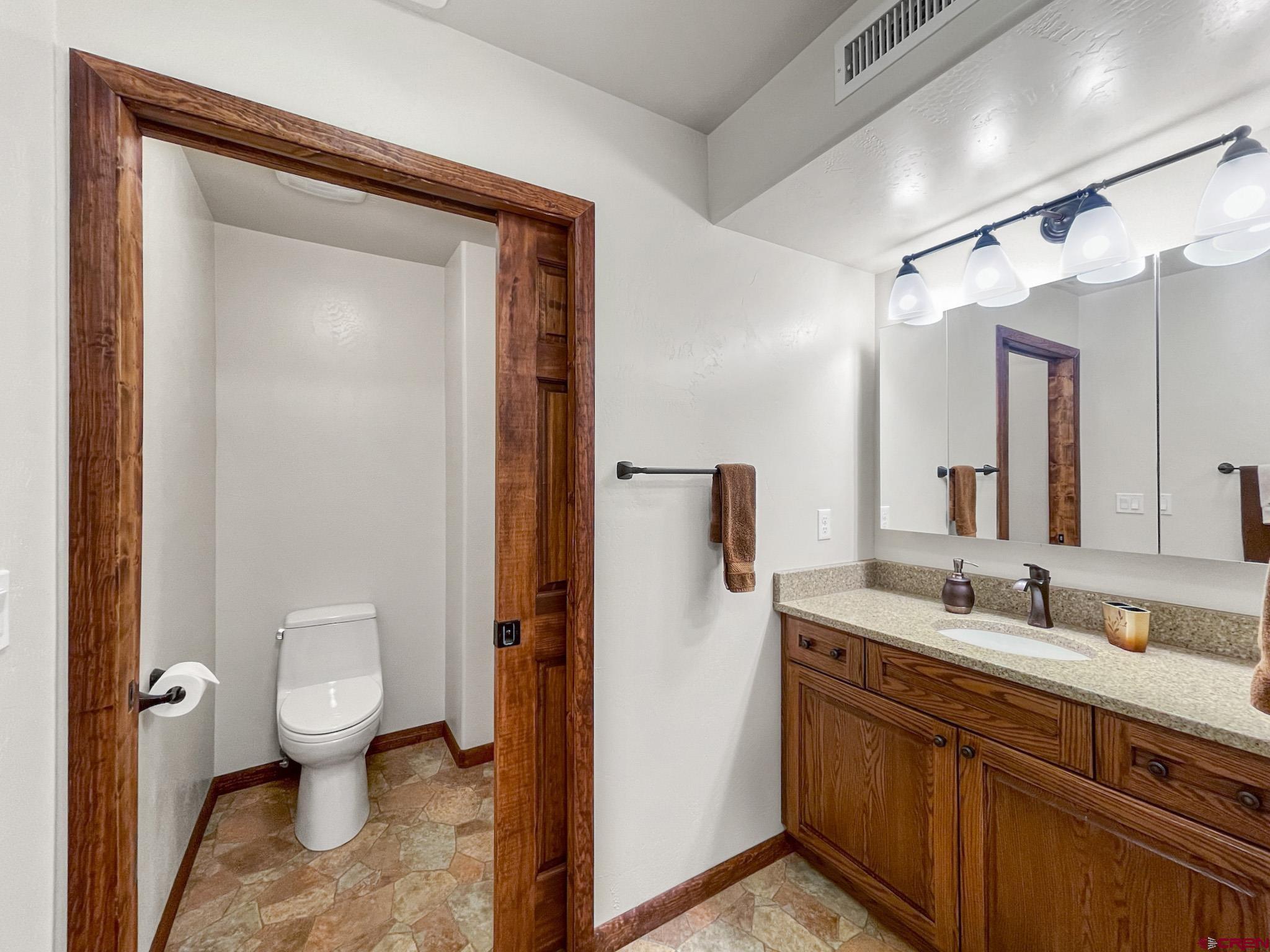 2984 Black Canyon Road Crawford, CO 81415 - Photo 25 of 35 a spacious bathroom with a granite countertop sink toilet and shower