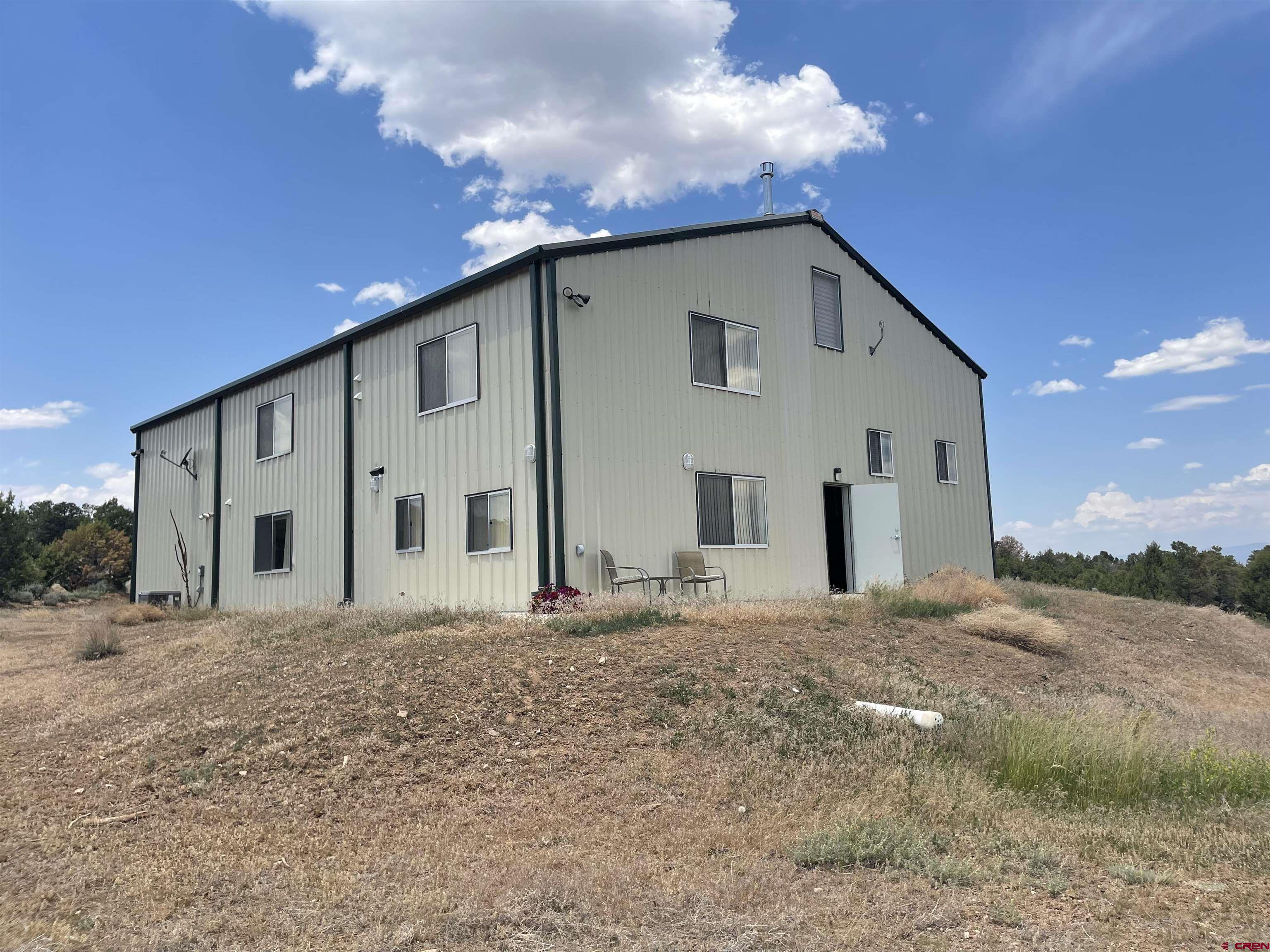 2984 Black Canyon Road Crawford, CO 81415 - Photo 3 of 35 a view of a house with a yard