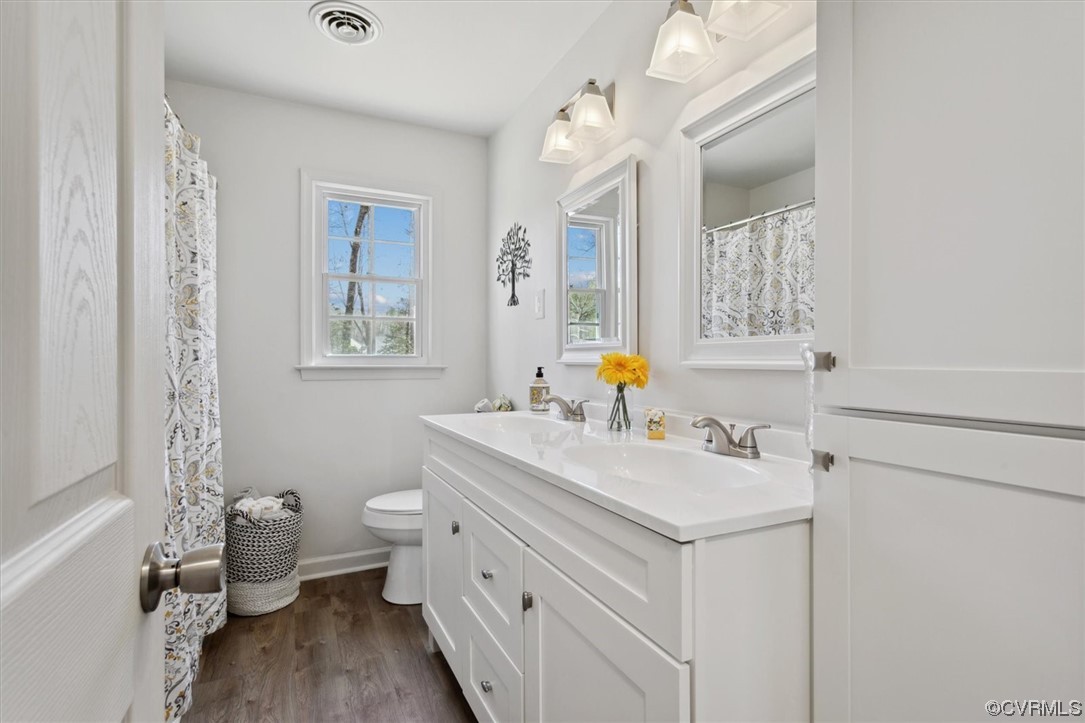 206 Mildred Drive Williamsburg, VA 23188 - Photo 13 of 34 a bathroom with a sink toilet vanity and mirror