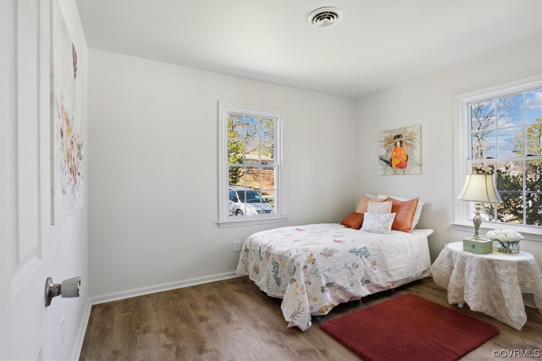 206 Mildred Drive Williamsburg, VA 23188 - Photo 18 of 34 a bedroom with a bed and wooden floor
