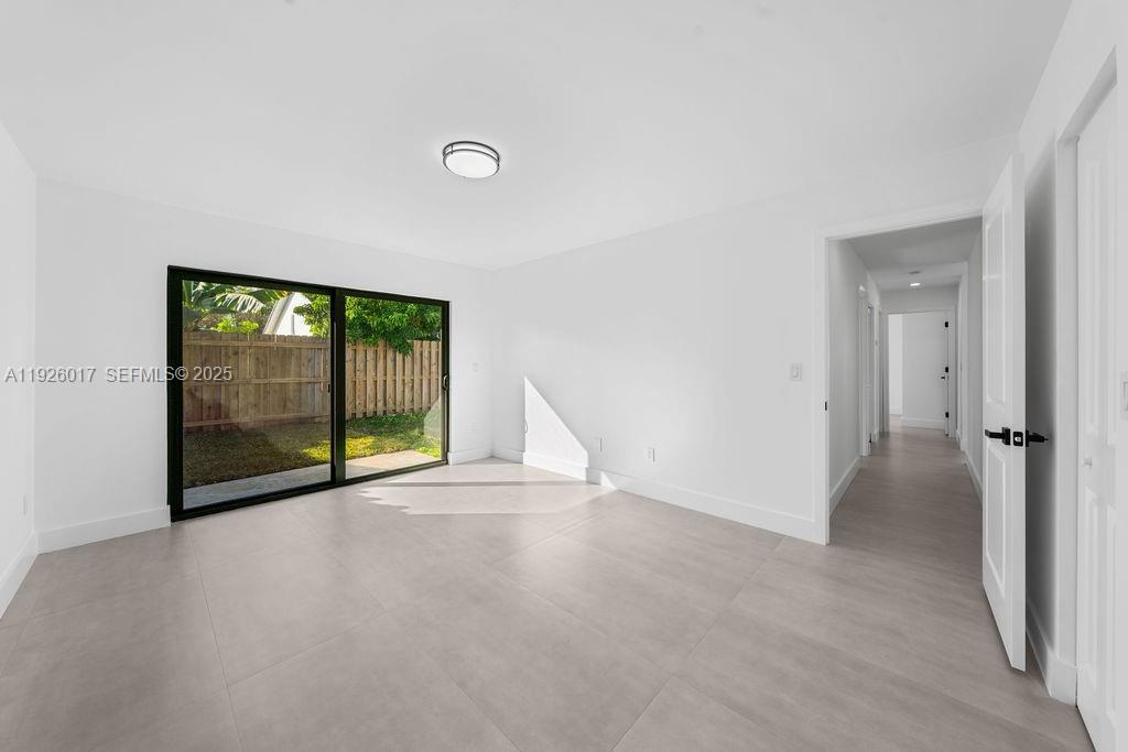 13338 Southwest 113th Place Miami, FL 33176 - Photo 11 of 32 a view of empty room with floor to ceiling window