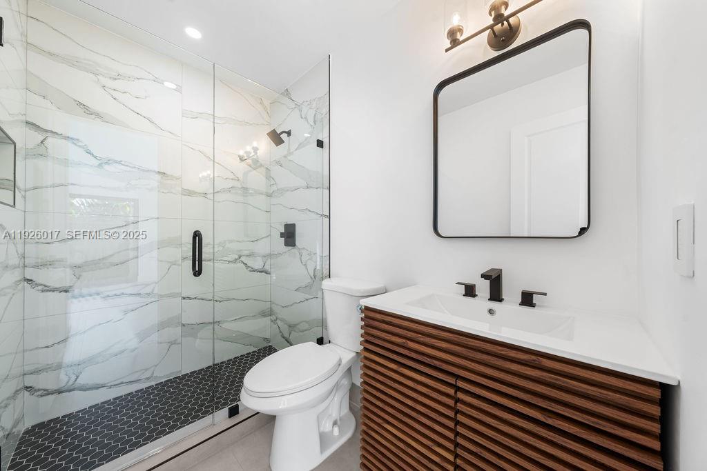 13338 Southwest 113th Place Miami, FL 33176 - Photo 15 of 32 a bathroom with a sink toilet and shower