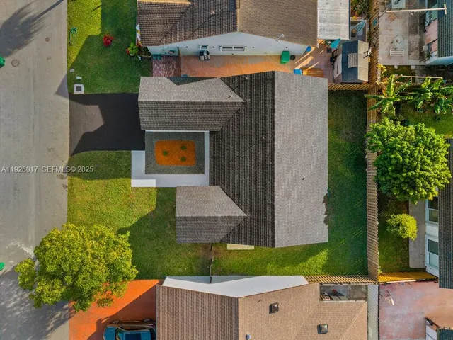 an aerial view of a house with swimming pool