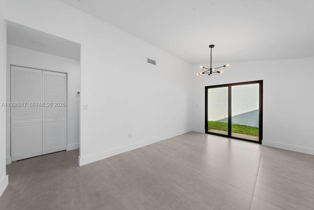 13338 Southwest 113th Place Miami, FL 33176 - Photo 21 of 32 a view of an empty room with window