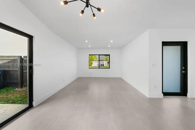 a view of an empty room and a window