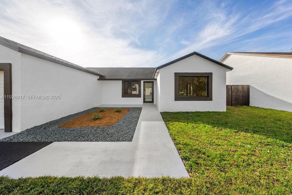13338 Southwest 113th Place Miami, FL 33176 - Photo 29 of 32 a front view of house with yard