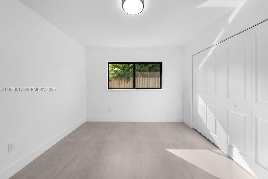13338 Southwest 113th Place Miami, FL 33176 - Photo 9 of 32 an empty room with a window