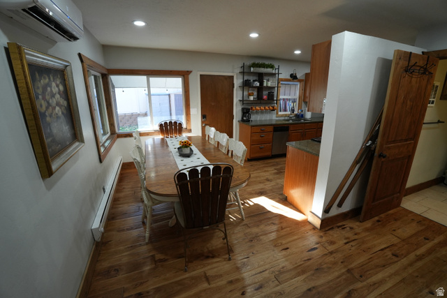 3711 North Canyon Road Provo, UT 84604 - Photo 21 of 42 Dining space featuring dark wood-style floors, a wall unit AC, a baseboard heating unit, and recessed lighting