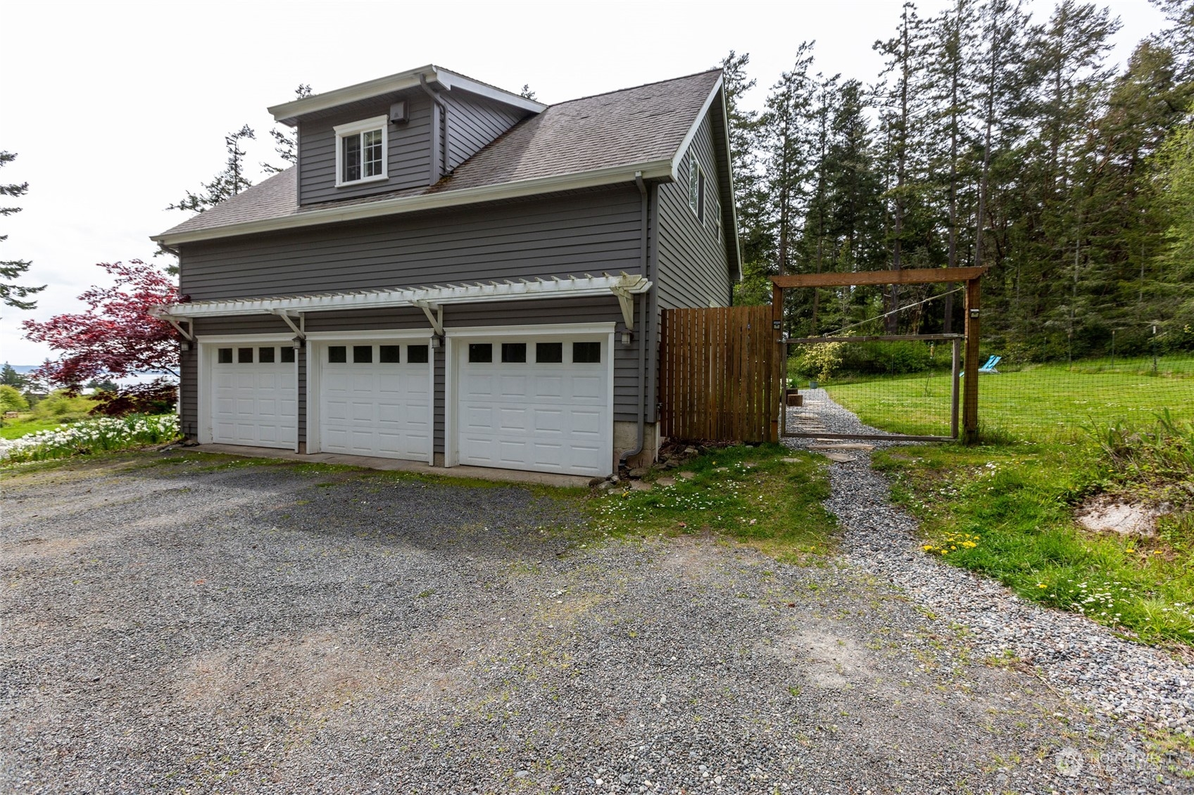 2858 Pear Point Road Friday Harbor, WA 98250 - Photo 11 of 40 a view of house with backyard and garden