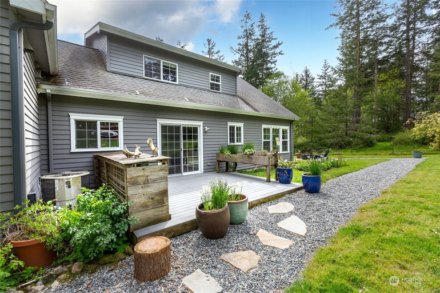 2858 Pear Point Road Friday Harbor, WA 98250 - Photo 8 of 40 a front view of a house with a garden and patio