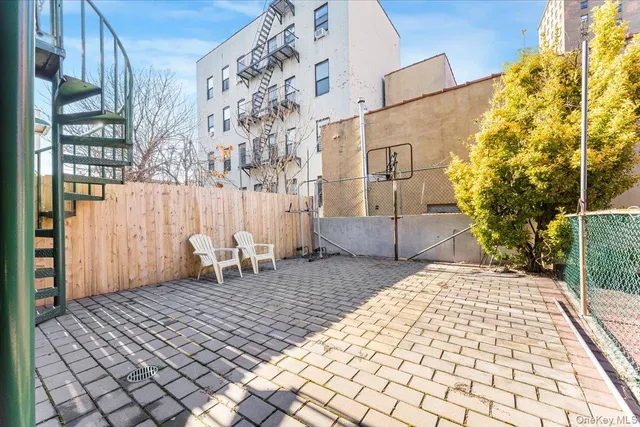 a backyard of a house with barbeque oven