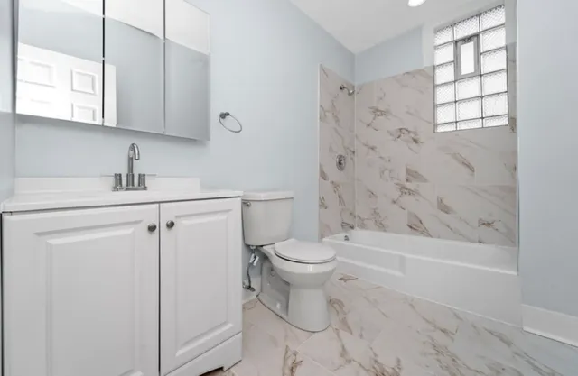 a bathroom with a sink toilet and shower