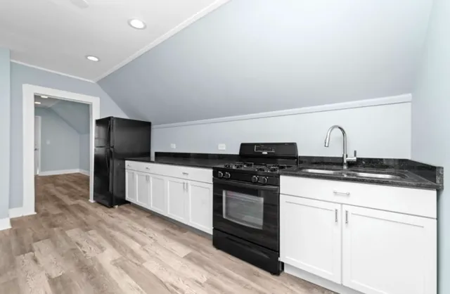 a kitchen with a sink stove and refrigerator