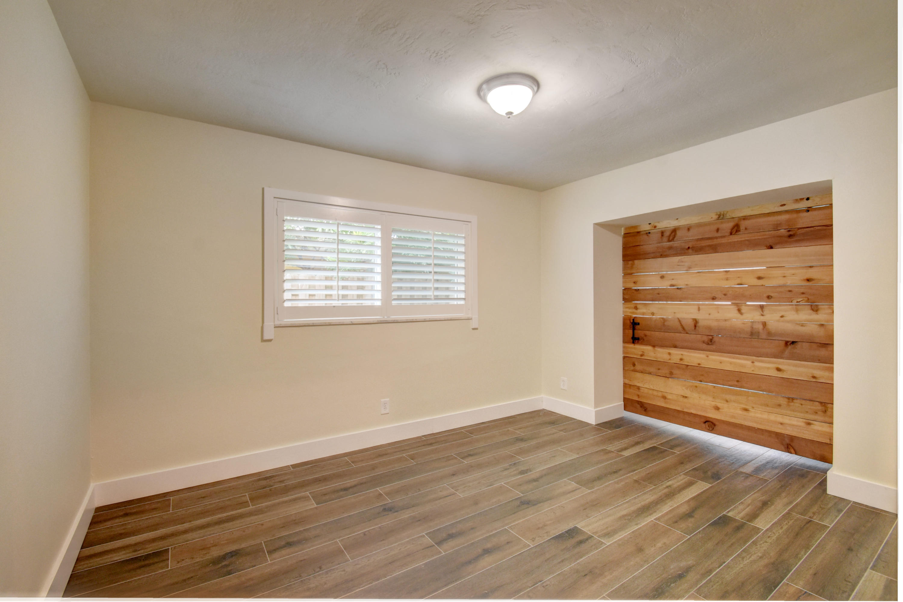 1266 Southwest 5th Street Boca Raton, FL 33486 - Photo 23 of 30 a view of an empty room with a window and wooden floor