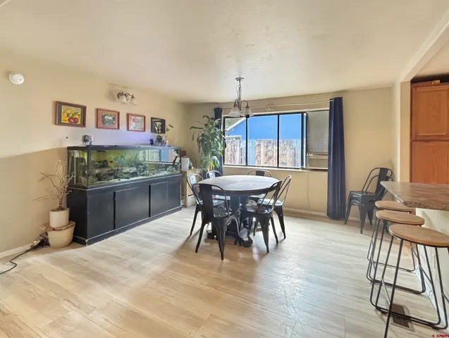 a view of a dining room with furniture and window