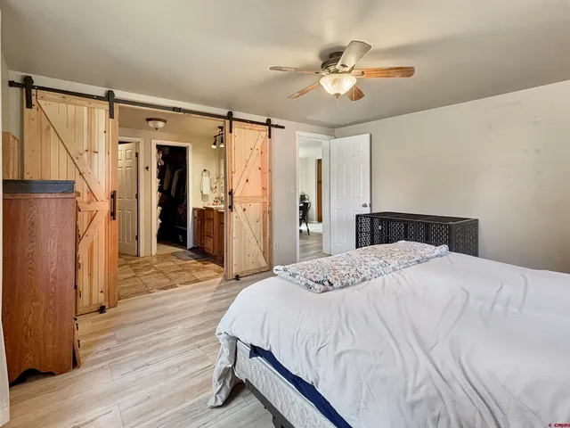 a spacious bedroom with a bed and a chandelier